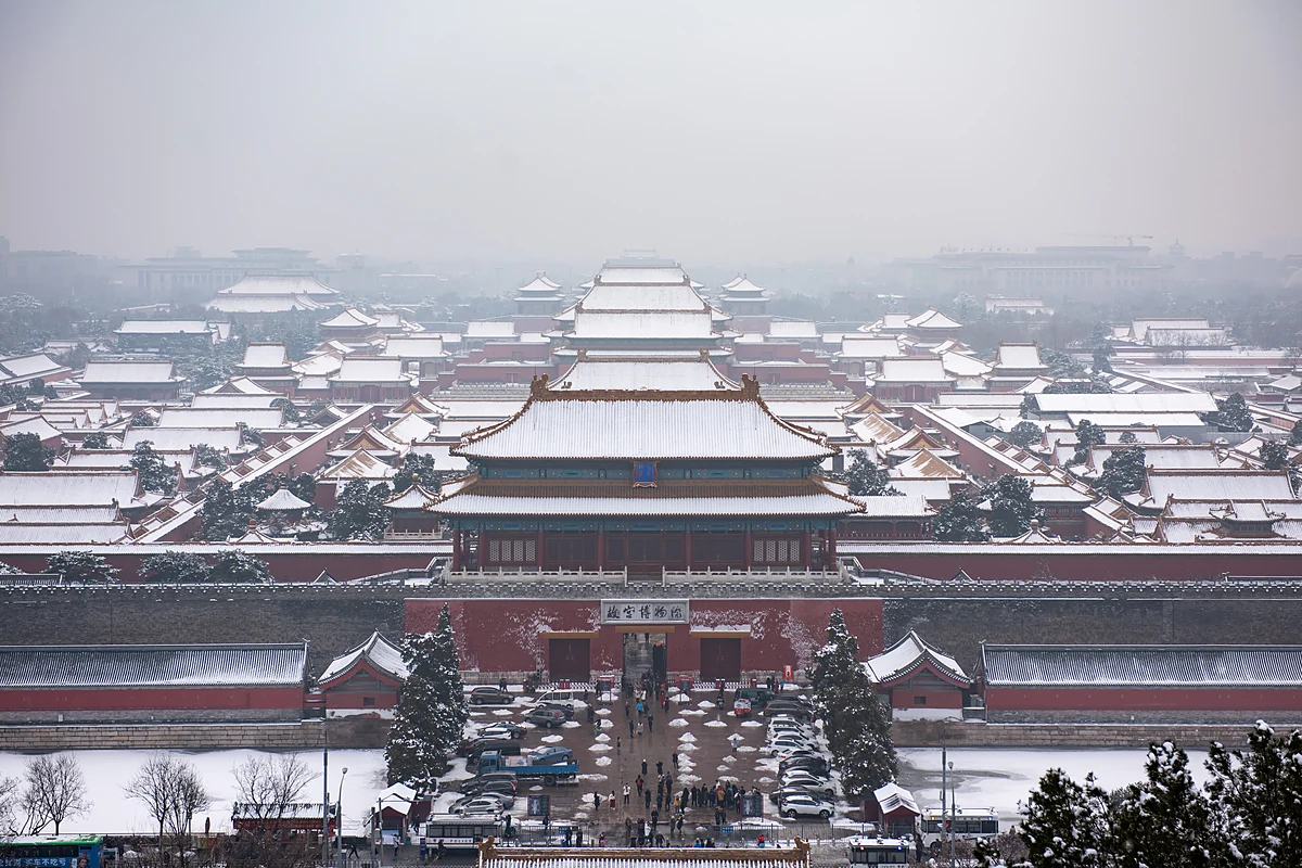 Snow on the yellow roofs of the Forbidden City seen from Jingshan Park on a grey January morning, Beijing