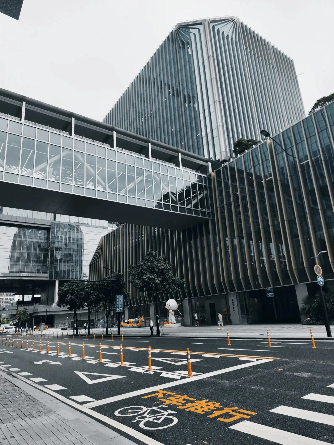 Modern Guangzhou business district street with pedestrian skybridge