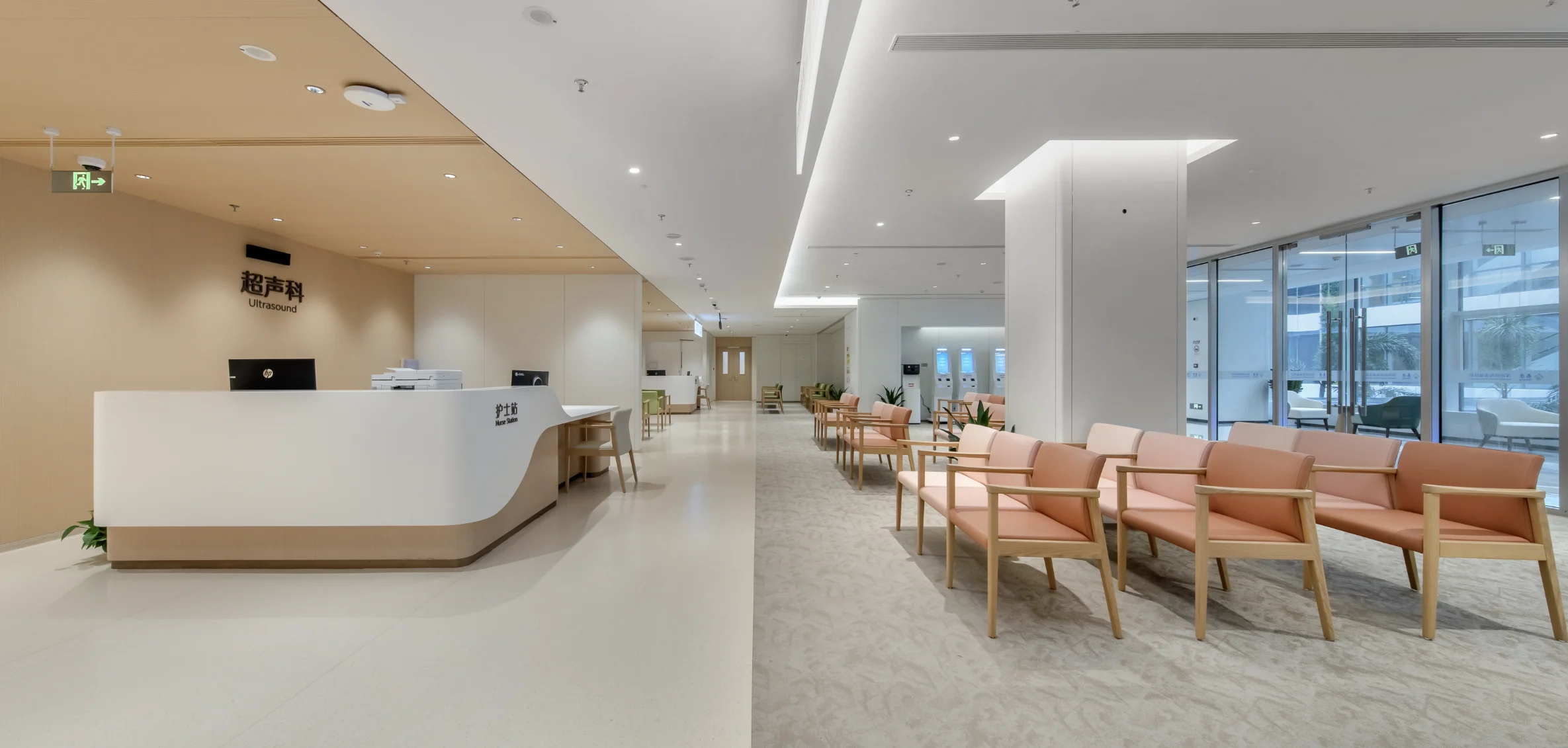 Bilingual Ultrasound and Nurse Station desk beside peach-cushion waiting chairs at the Shenzhen partner facility