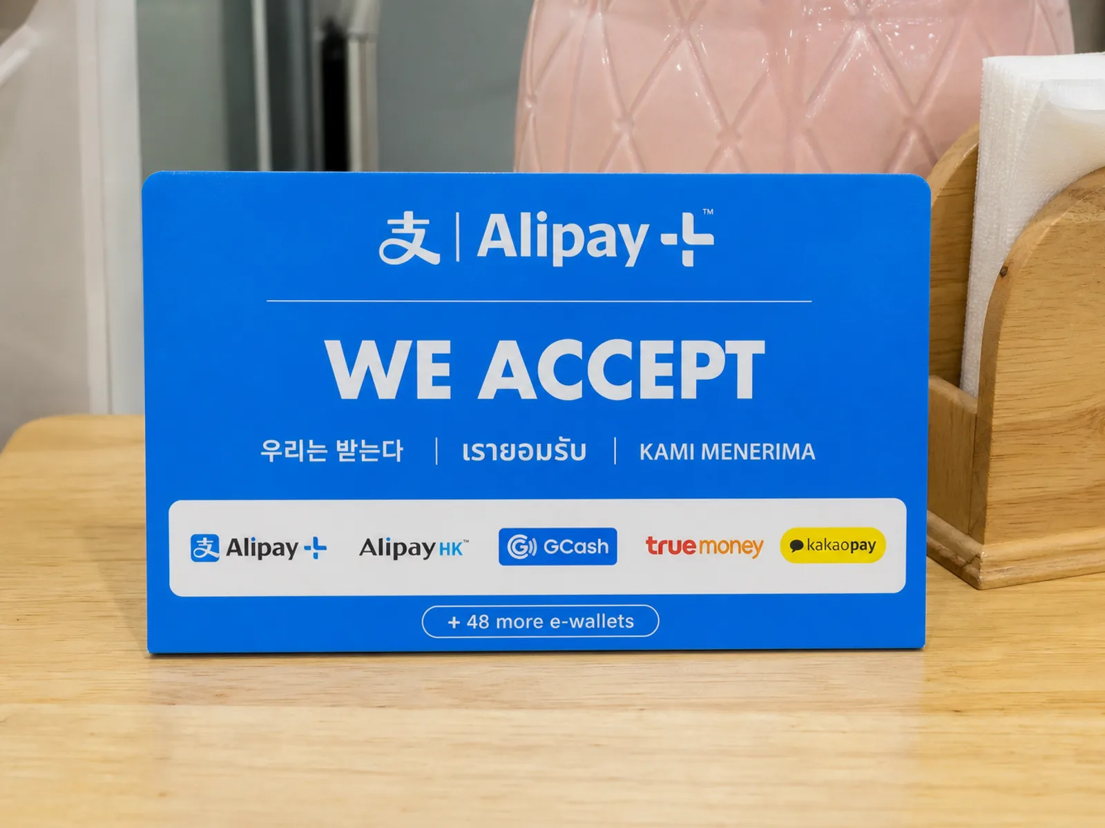 Alipay+ we-accept sign on a local shop counter