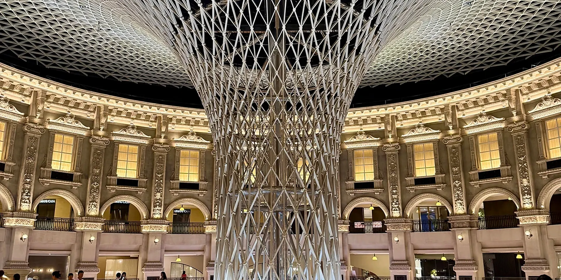 Central atrium of the Louvre International Furniture Exhibition Center in Lecong, Shunde, Foshan: a white lattice sculpture rises under the dome, ringed by an arcaded gallery
