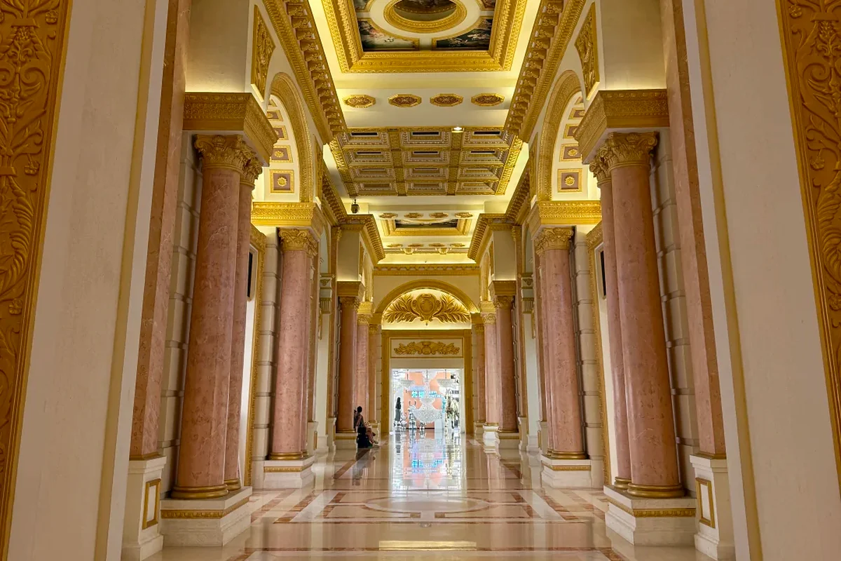 Gilded neoclassical corridor with pink marble columns and a coffered ceiling inside the Louvre International Furniture Exhibition Center, Lecong, Shunde, Foshan