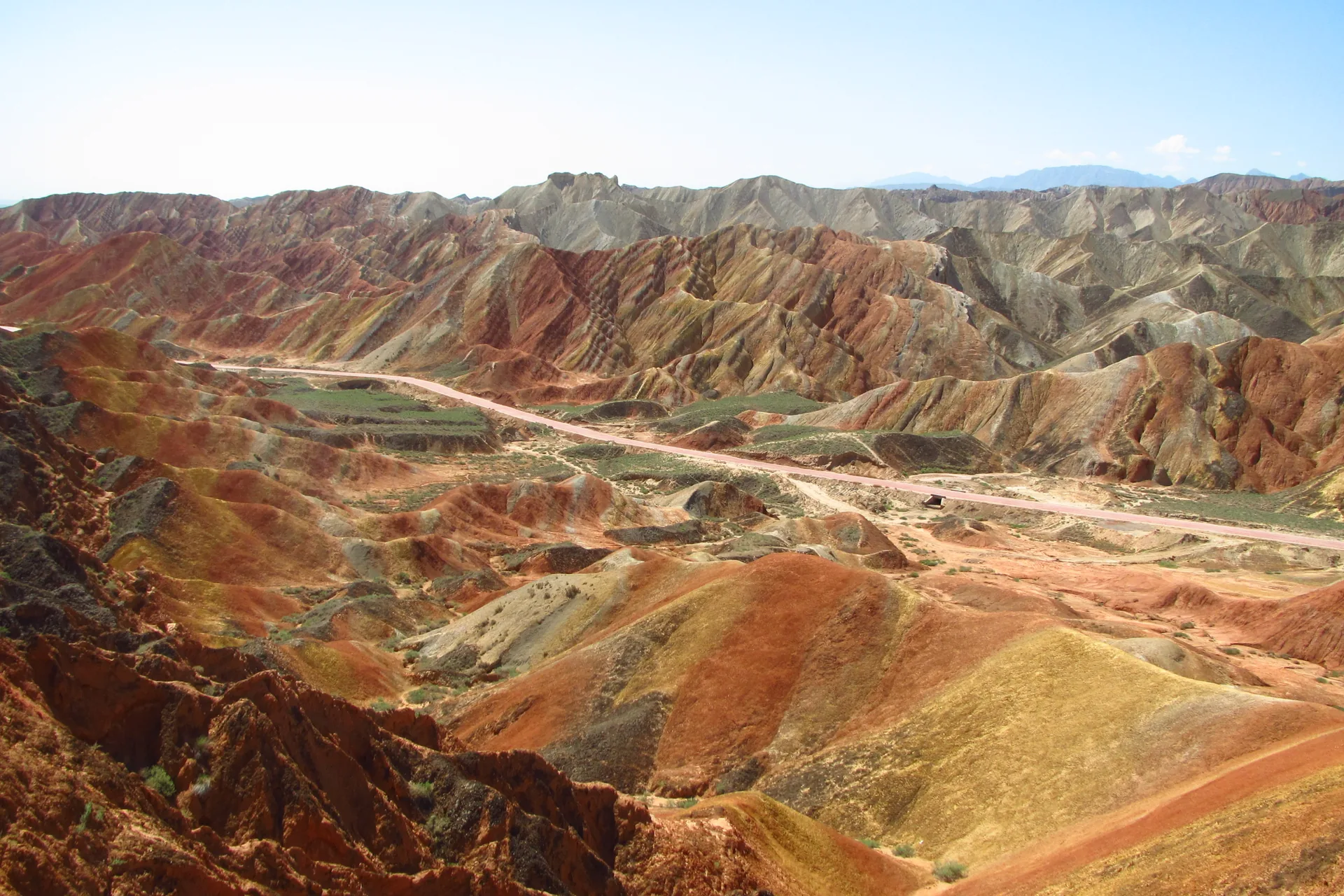 Visitors on a viewing platform at sunset above the red ridges of Zhangye Danxia, the Rainbow Mountains in Gansu